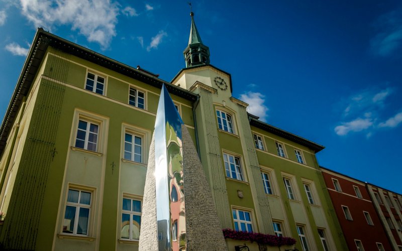 Kościół z wysoką wieżą pośród zielonych wzgórz