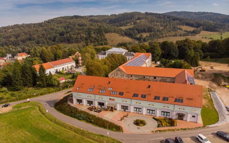 Kompleks budynków z czerwonymi dachami widziany z lotu ptaka